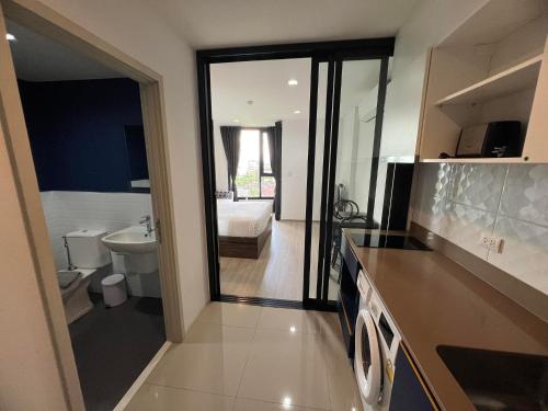 a bathroom with a sink and a toilet and a tub at The Base Central Phuket in Phuket