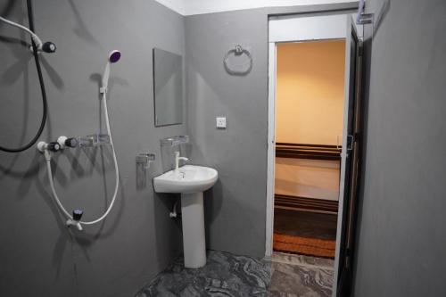 a bathroom with a shower and a sink at Aaliya Bay in Pottuvil