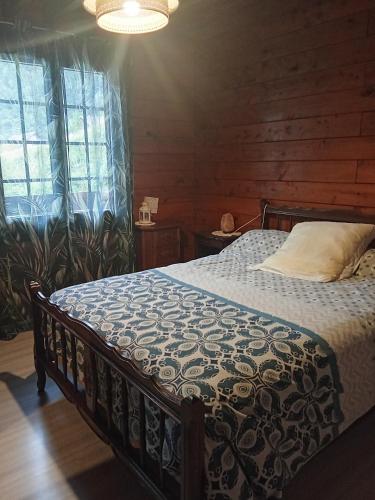 a bedroom with a bed in a wooden room at Chalet Borce 64 in Borce