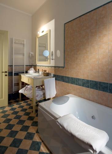 a bathroom with a bath tub and a sink at Relais Corte Cavalli in Ponti Sul Mincio