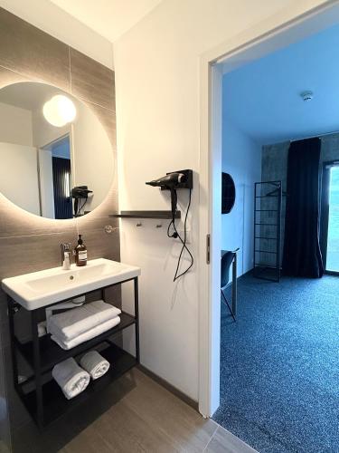 a bathroom with a sink and a mirror at Seljavellir Guesthouse in Höfn