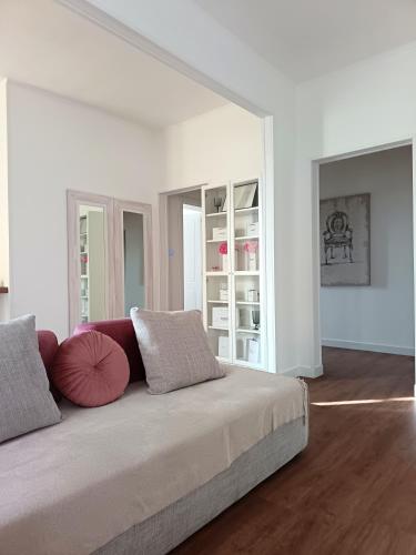 a white room with a large bed with pillows at Lodge 46 Luxury Apartment in Marghera