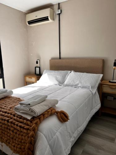 a bedroom with a white bed with a blanket on it at Casa Cibelli in Rufino