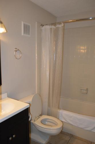 a bathroom with a toilet and a shower and a sink at The Summit Condominiums in Panama City Beach