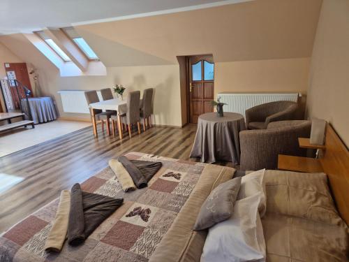 a bedroom with a bed and a living room at Diófa Vendégház in Eger