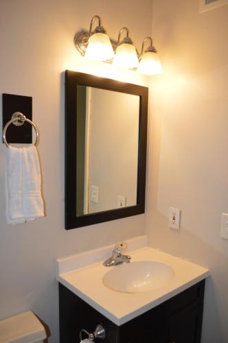 a bathroom with a sink and a mirror at The Summit Condominiums in Panama City Beach