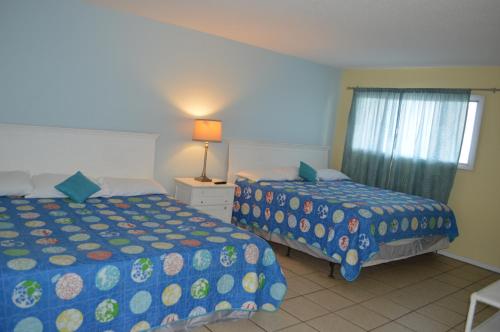 a bedroom with two beds and a window at The Summit Condominiums in Panama City Beach