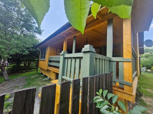 a house with a fence in front of it at Osada Bura Polana - drewniane domki z sauną in Ujsoły