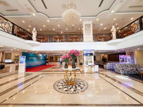 a lobby with a table with flowers on it at A25 Signature Hotel in Hanoi