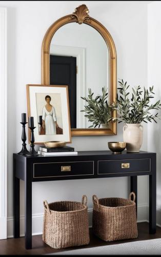 a black console table with a mirror and baskets at Luxury Room In McDonough in McDonough
