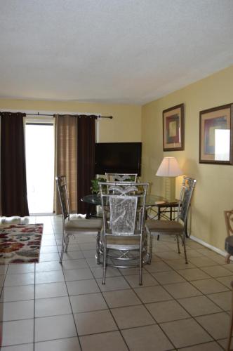 a living room with a table and chairs at The Summit Condominiums in Panama City Beach