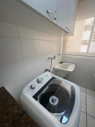 a small bathroom with a toilet and a sink at Apto 3 Quartos com Ar, Piscina, Garagem - Cuiabá in Cuiabá