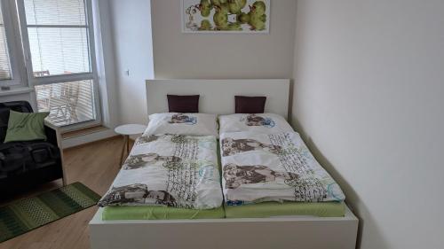 a bedroom with a bed with two pillows on it at Apartmán Velké Losiny in Velké Losiny