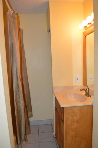 a bathroom with a sink and a shower curtain at The Summit Condominiums in Panama City Beach