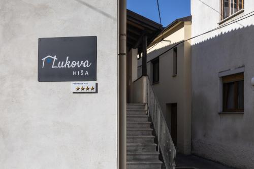 a sign on the side of a building with stairs at Lukova hiša- Luka's house in Vipava