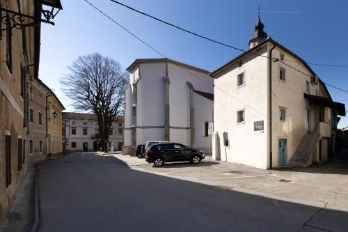 a car parked in a parking lot next to a building at Lukova hiša- Luka's house in Vipava