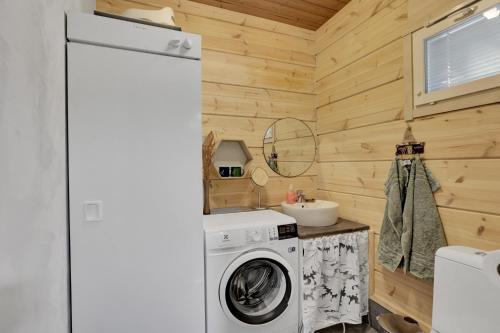a washer and dryer in a tiny house at Villa Winter - Valkea Homes in Pyhätunturi