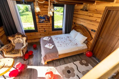 a bedroom of a log cabin with a bed and a table at Pallas Suit in Ardeşen
