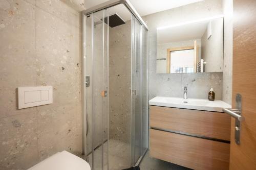 a bathroom with a shower and a toilet and a sink at Studio Omis in Zermatt