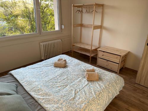 a bedroom with a bed with two towels on it at Apartmán Volary in Volary