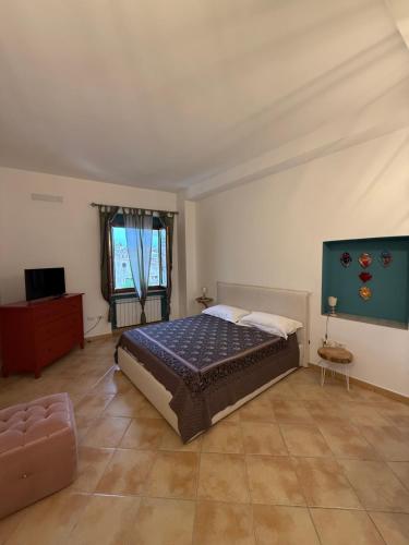a bedroom with a bed and a couch at Affittacamere Le Canossiane in Piedimonte dʼAlife