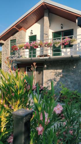a house with flower boxes on the balcony at Jovanov Residence - the Landscape Beauty in Dolna Matka