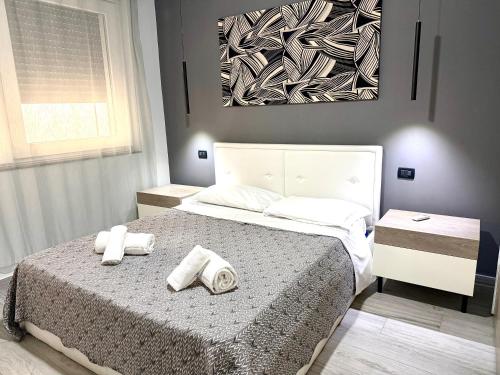 a bedroom with a bed with two towels on it at Luxury Sofi in Giardini Naxos