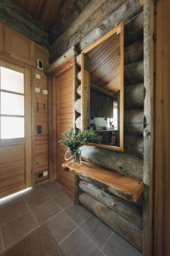 a room with a wooden wall with a bench and a window at Kelo Naava in Ruka