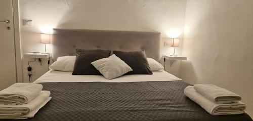 a bedroom with a large bed with two pillows at Pisa tower view 2 in Pisa