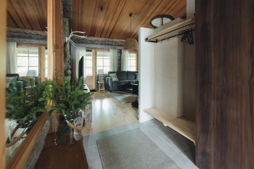 a hallway with a living room and a living room with a couch at Kelo Naava in Ruka