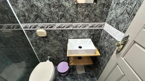 a small bathroom with a sink and a toilet at Hotel Morada de Leste Pontal in Pontal do Paraná