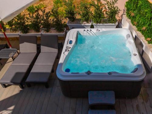 a bath tub sitting on top of a deck at DOMO MARE E TERRA Boutique Rooms and Spa in Posada