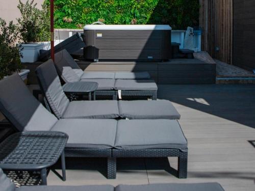 a group of chairs and tables on a patio at DOMO MARE E TERRA Boutique Rooms and Spa in Posada