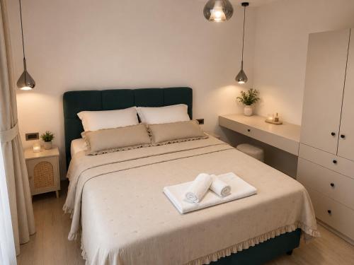 a bedroom with a bed with two towels on it at Apartments Villa Nikola- one minute to the beach in Gradac