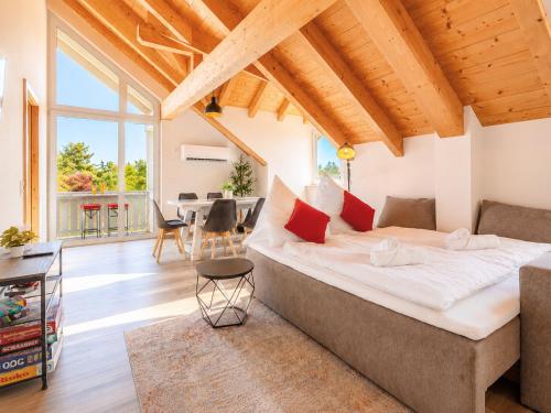 a bedroom with a large bed and a living room at Bright Lake View Apartment with Balcony and Air Conditioning in Tutzing
