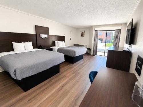 a hotel room with two beds and a window at Quality Inn Harrodsburg in Harrodsburg