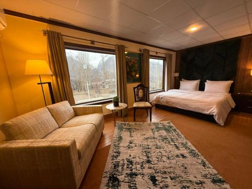 a living room with a couch and a bed at The Guest House Hunza in Karimabad Hunza