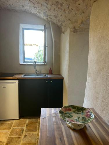 a kitchen with a table and a sink and a counter at Ancienne eglise in Vallérargues