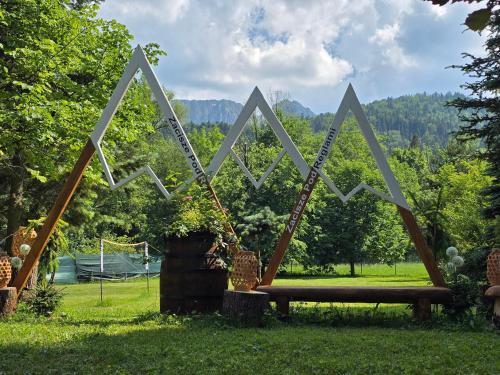 a park with a swing and a bench in the grass at Zacisze Pod Reglami & Sauna in Zakopane
