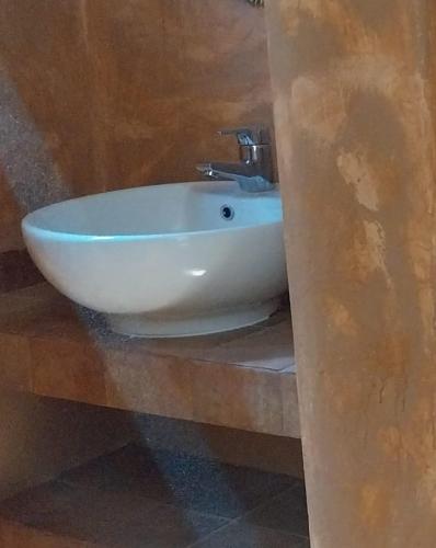 a white sink sitting on a counter in a bathroom at Sea View Garden in Poros