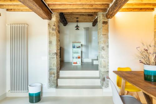 a dining room with wooden ceilings and a table and chairs at Relais Tosca in Cortona