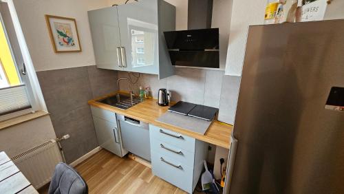 a small kitchen with a counter and a refrigerator at Wohnung in Datteln in Datteln