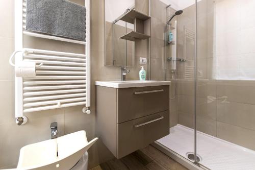 a bathroom with a shower and a sink and a toilet at Moon Bologna in Bologna