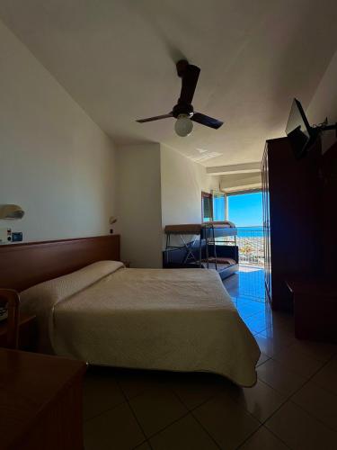 a bedroom with a bed and a ceiling fan at Hotel Trocadero - Koolibry Hotels in Cervia