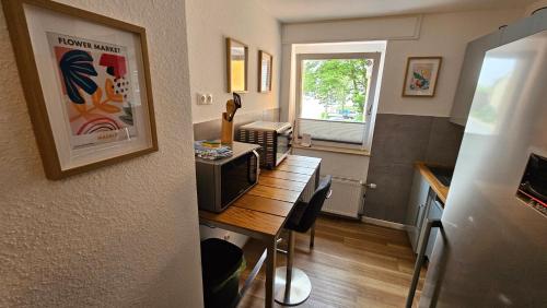 a small kitchen with a table with a microwave at Wohnung in Datteln in Datteln