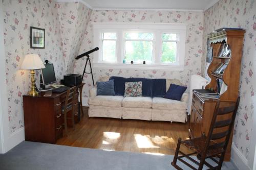 a living room with a couch and a window at Belgravia B&B in Truro