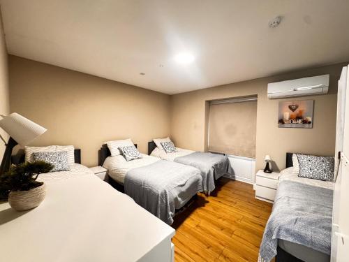 a room with three beds and a window at Ambassador House in Carrick on Shannon