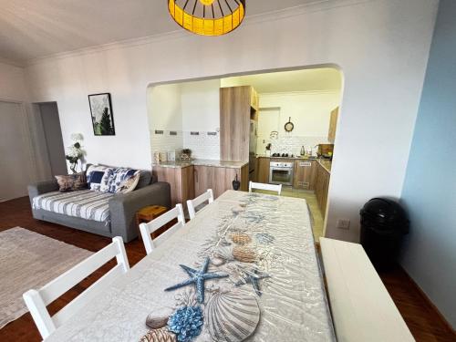 a living room with a dining room table with a starfish on it at Seaview Sunsets in Gqeberha