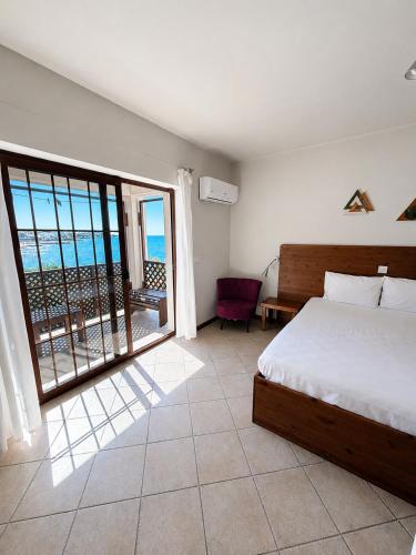 a bedroom with a bed and a view of the ocean at Riviera Beach Bungalows in Kyrenia