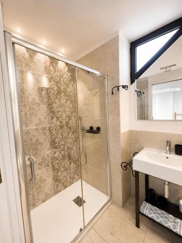 a bathroom with a shower and a sink at VR-Room in Forte Village
